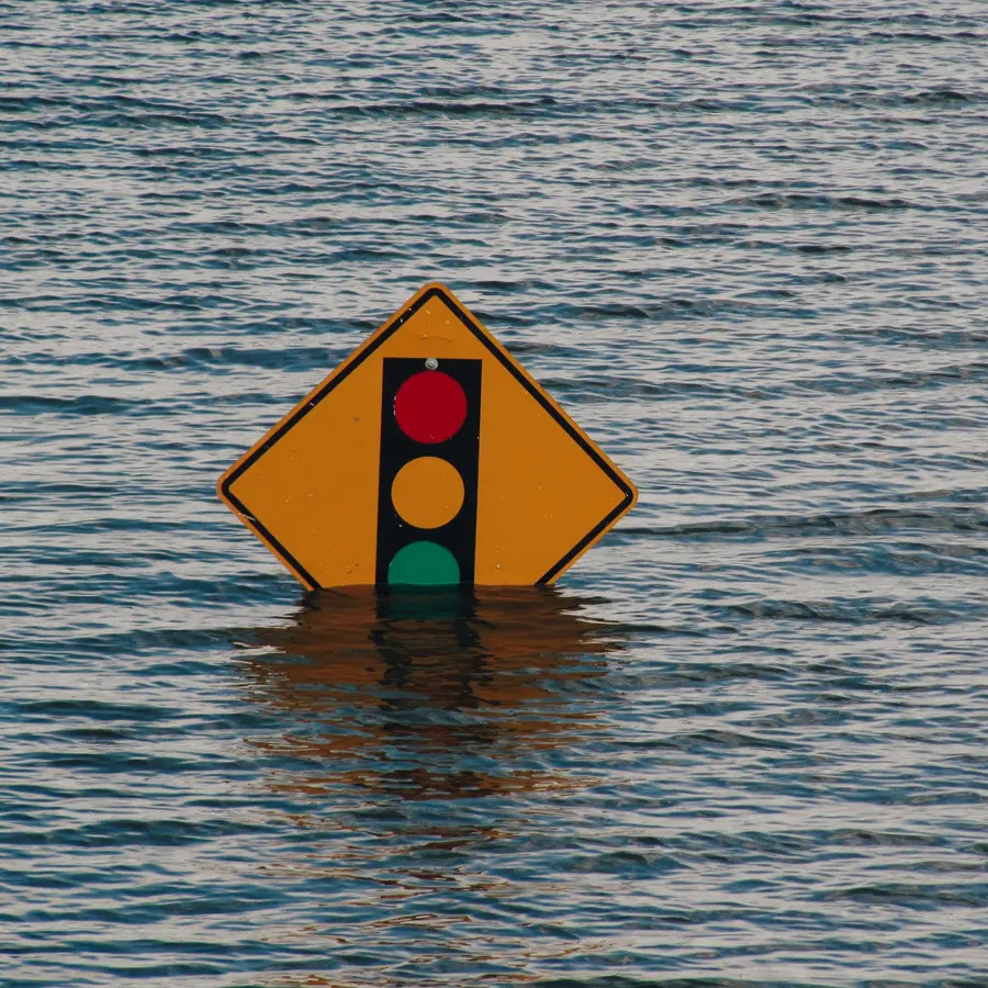 Flood warning sign standing in flood water