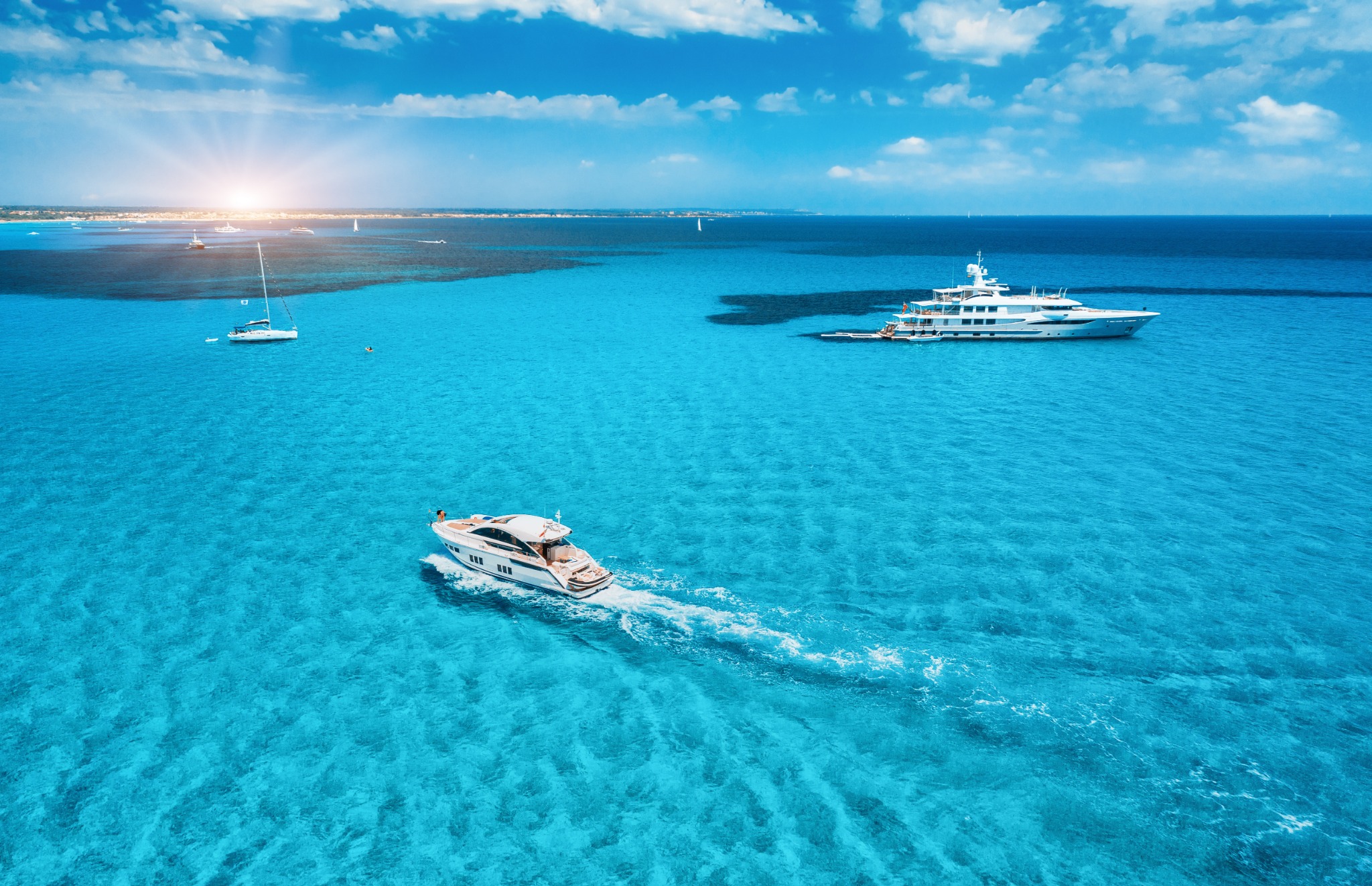 Aerial photograph of yacht charter vessels on blue water